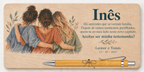 Plaque printed in colour with three friends hugging, the name Inês and a bamboo pen