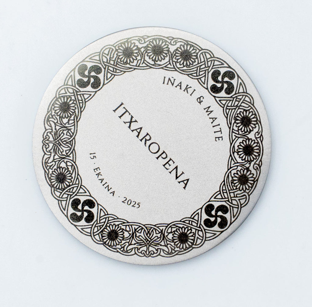 Basque Country wedding coins with Lauburu symbols and traditional flowers engraved in a matt finish.