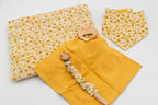 Mustard set with a floral blanket, bandana bib, mustard muslin square with a wooden bear teether and a dummy clip with a wooden clasp.