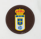 Round brown coaster with a colour football crest.