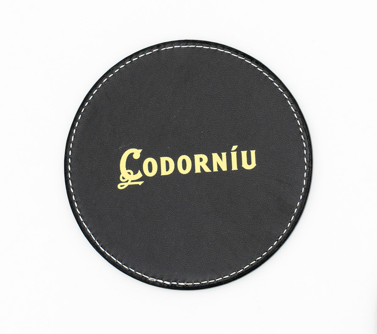 Round black coaster with a gold-coloured Codorníu logo.
