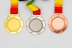 Medals with uncoloured curved blades around the central area.