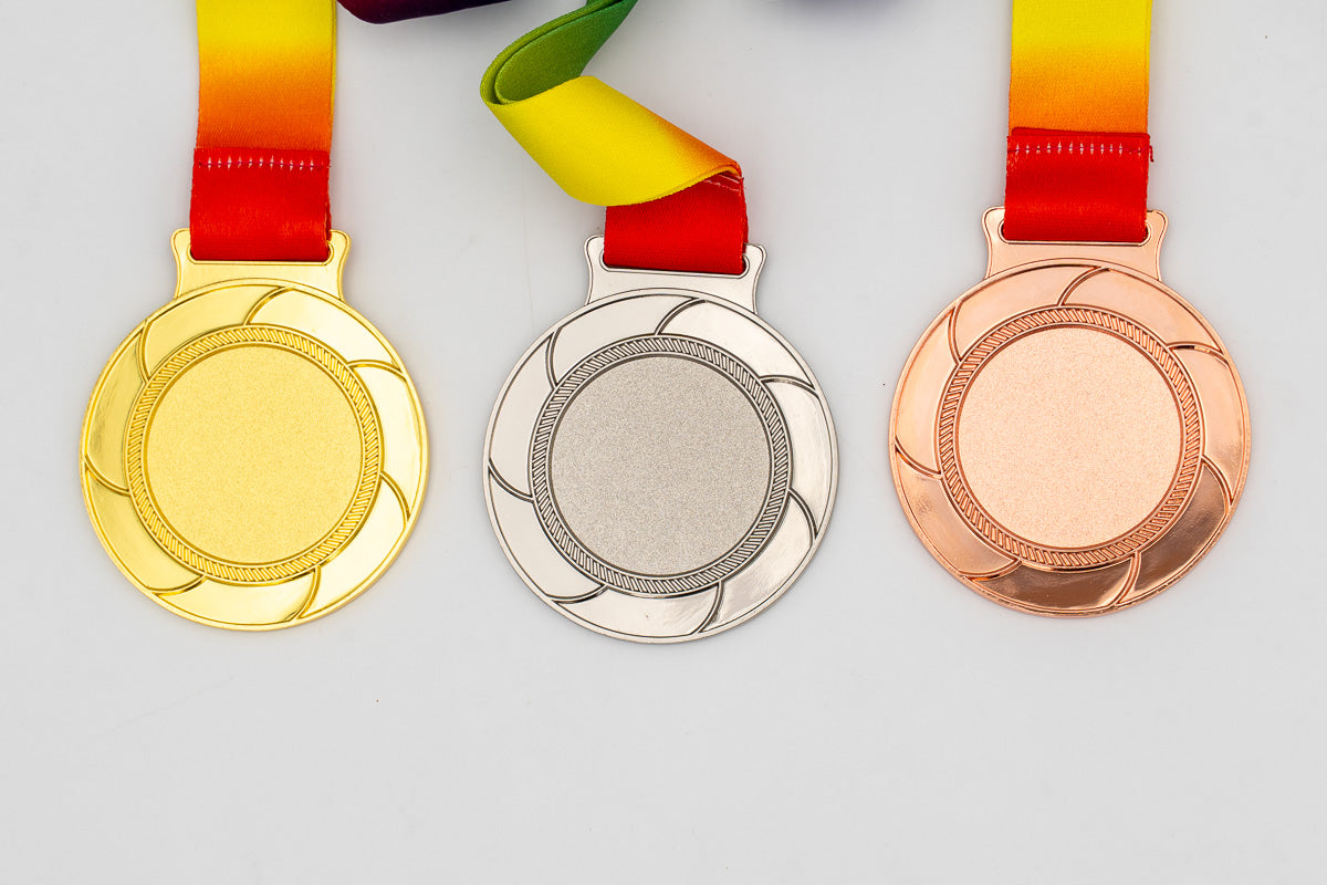 Medals with uncoloured curved blades around the central area.