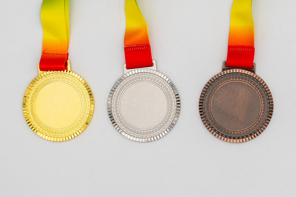 Medals with small relief motifs around the border and a flat centre.
