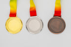 Medals with small relief motifs around the border and a flat centre.