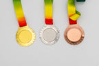 Medals with fine rays around the centre and red and yellow ribbons.