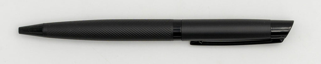 Black metal pen with a diagonal line pattern on the barrel and a clip.