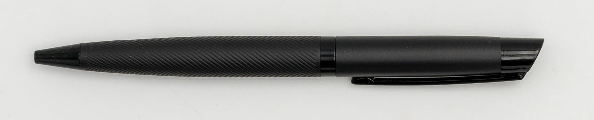 Black metal pen with a diagonal line pattern on the barrel and a clip.