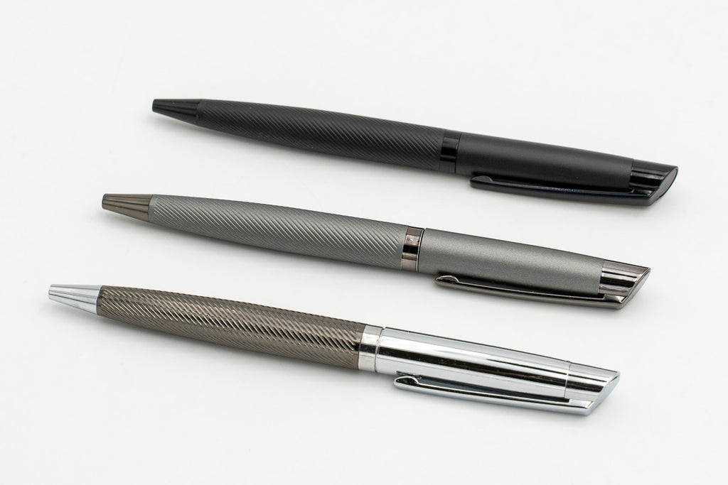 Black, grey and silver metal pens viewed diagonally.