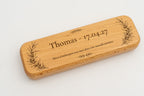 Wooden case with a name, date and branches engraved on the lid.