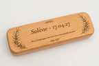 Angled view of a case with an engraved name, date and message.