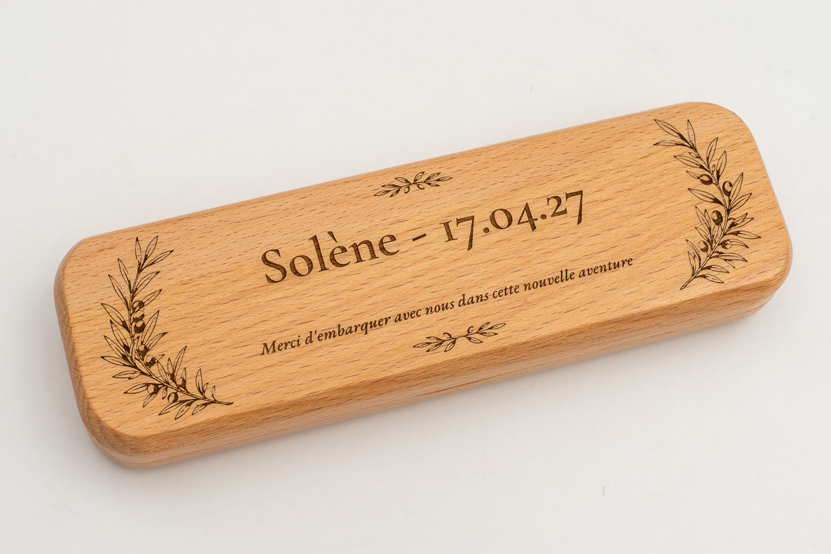 Angled view of a case with an engraved name, date and message.