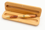 Open case with a two-tone wooden pen and engraved name.