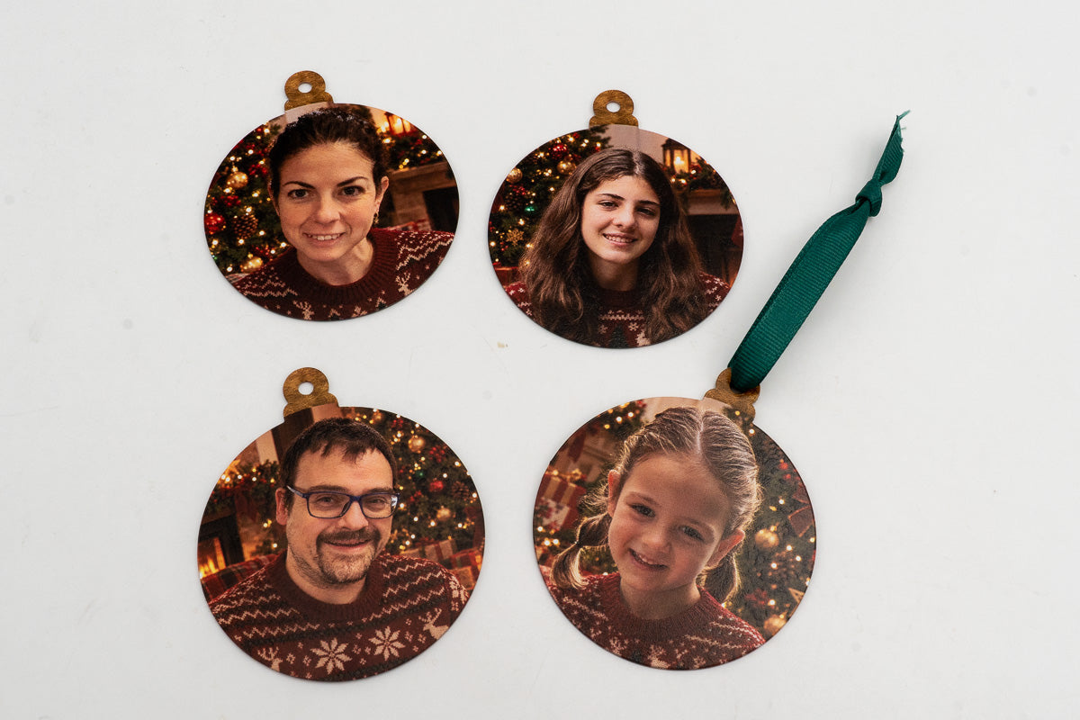Four circular ornaments with portraits and Christmas jumpers.