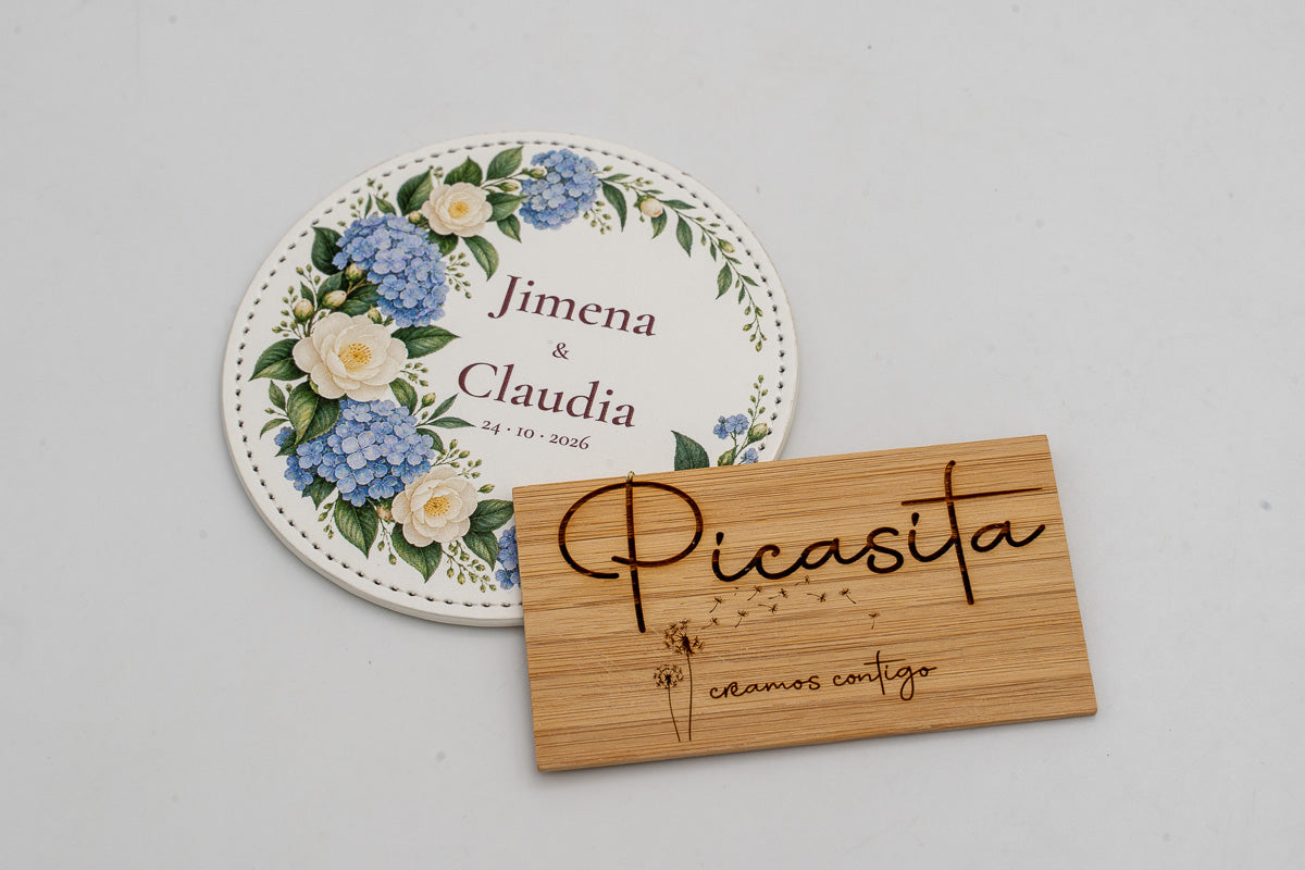 Round white coaster with blue flowers, Jimena and Claudia.
