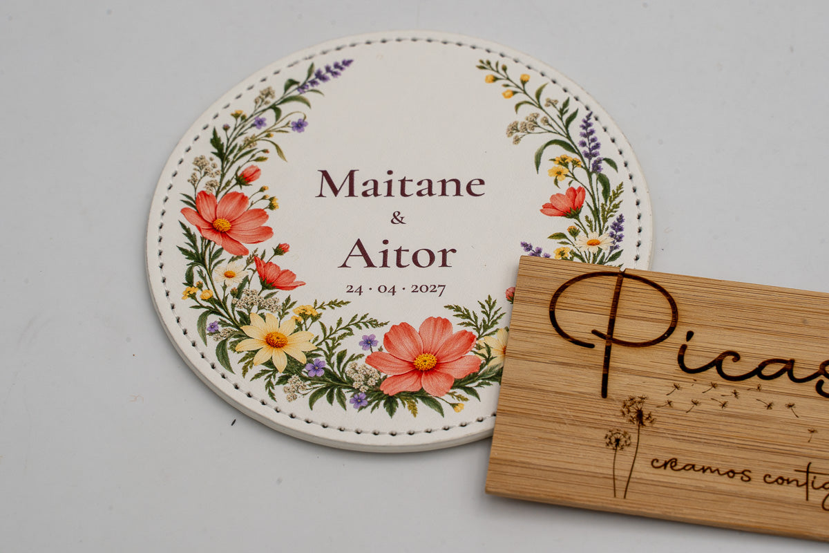 Round white coaster with colourful flowers, Maitane and Aitor.
