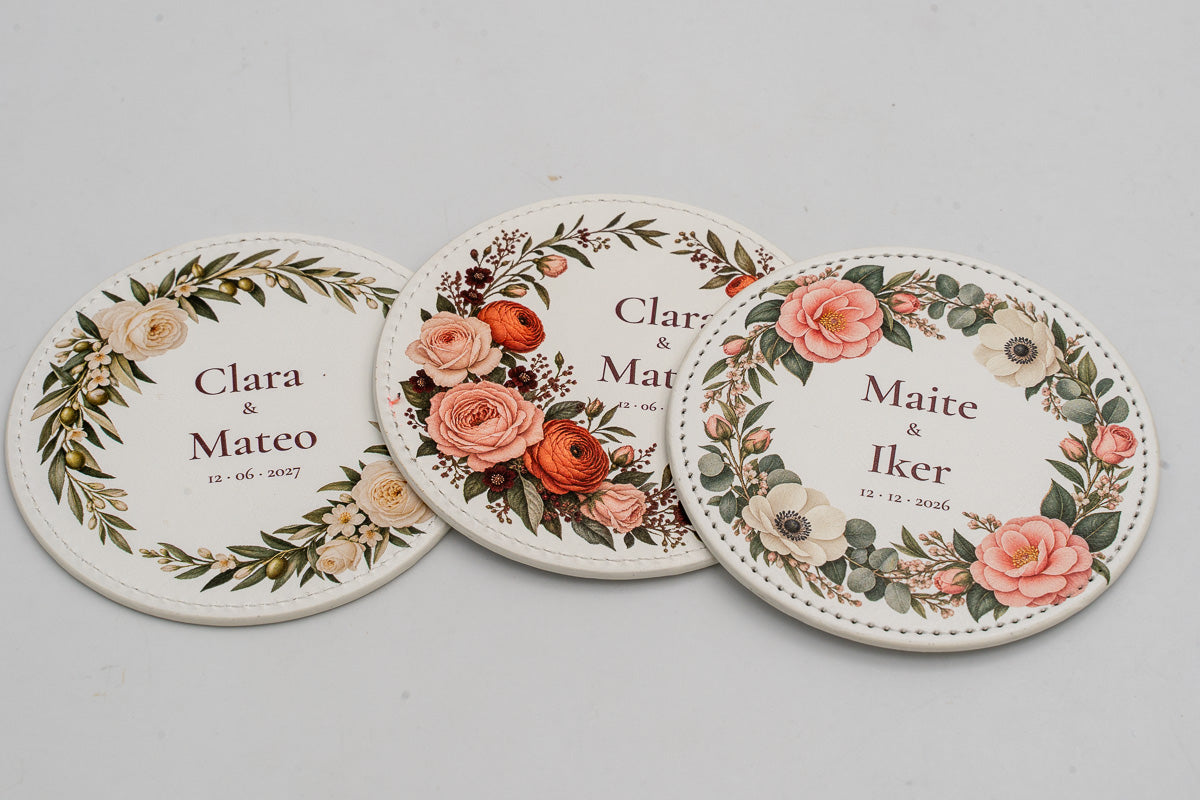 Round white coasters with different colourful floral designs.