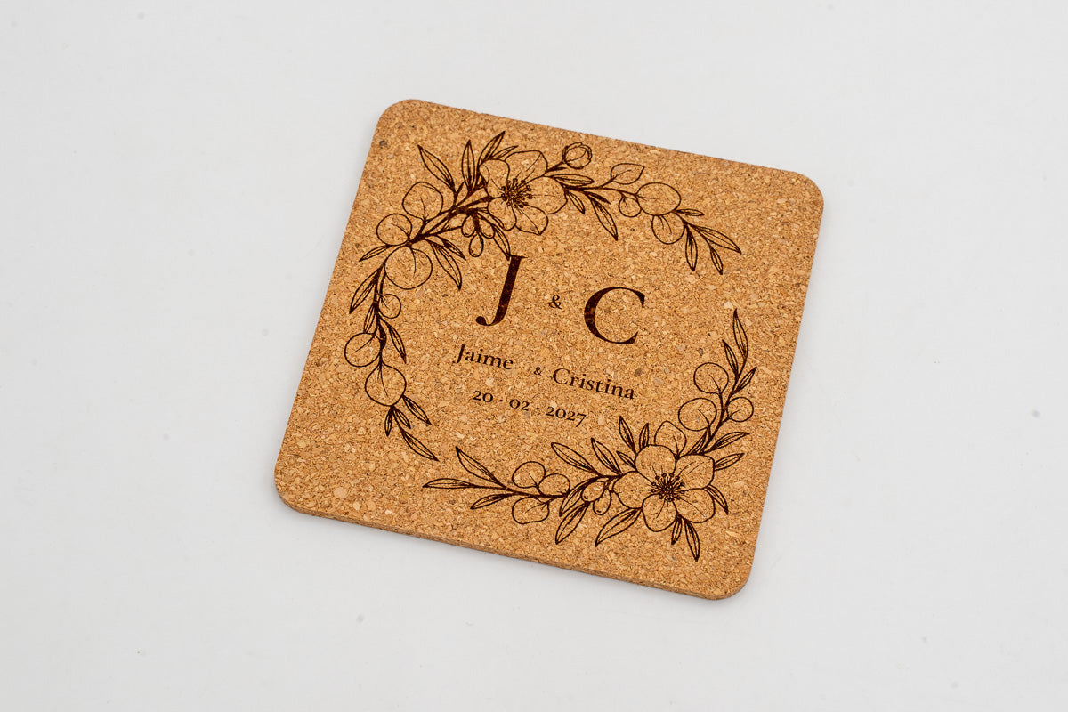 Square cork coaster with a floral wreath and initials J and C.