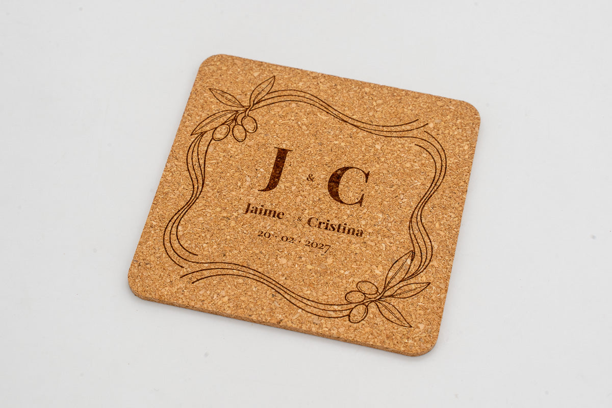 Square cork coaster with a decorative frame and initials J and C.