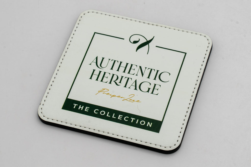 Square white coaster with a green Authentic Heritage logo.