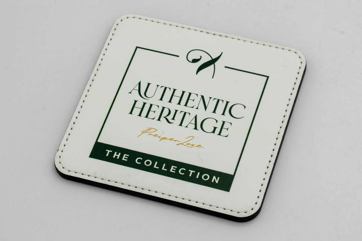 Square white coaster with a green Authentic Heritage logo.