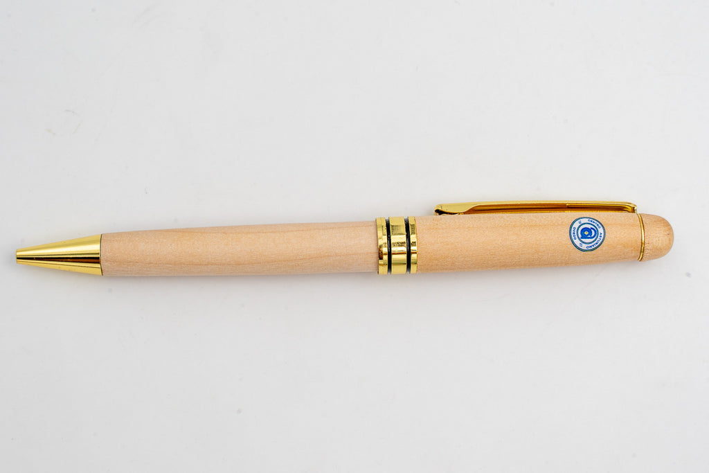 Light wooden pen with a coloured circular emblem and gold-coloured details.
