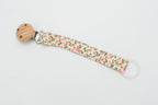 Fabric dummy clip with small pink flowers, green leaves and a round wooden clip