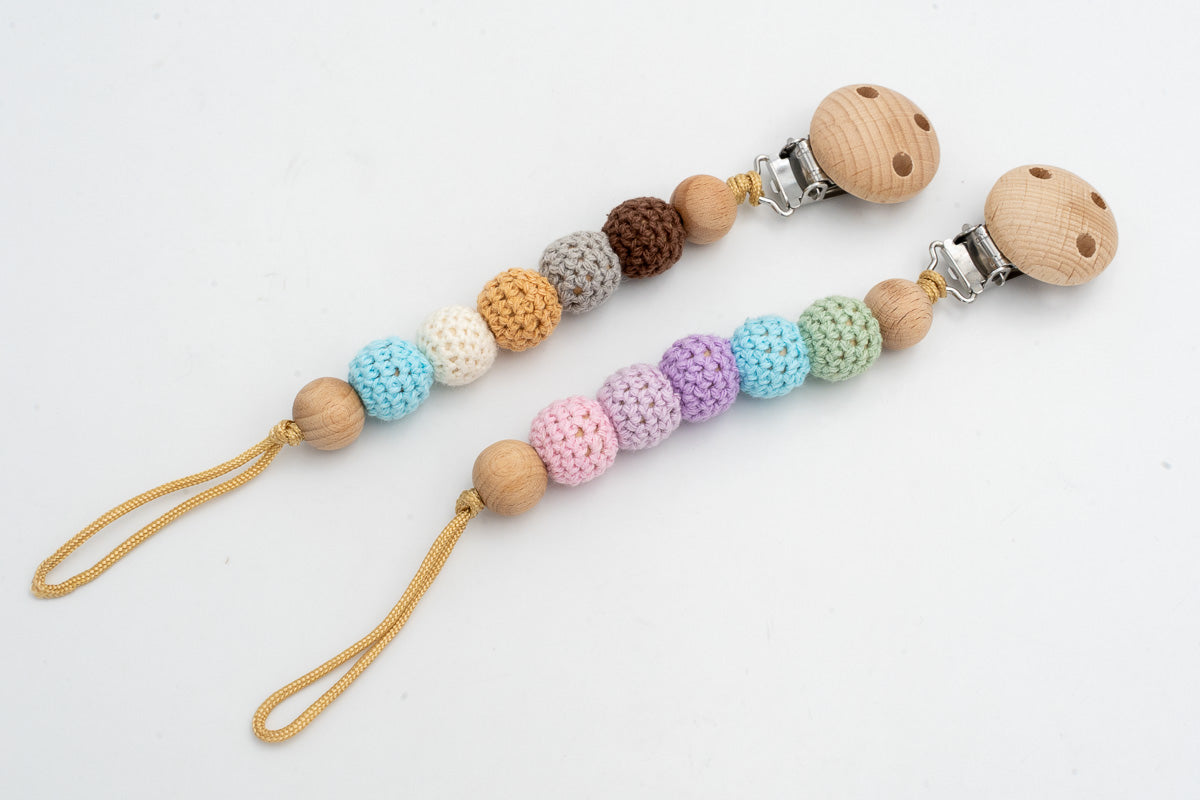 Dummy clips with crochet-covered beads in pastel and earth-tone combinations