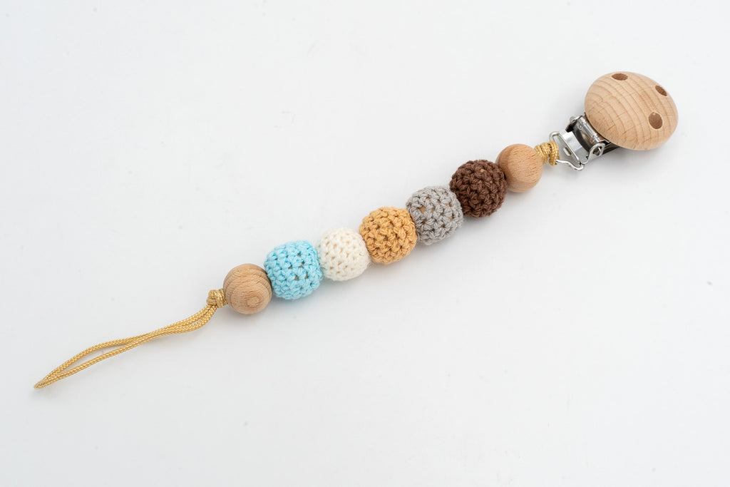Dummy clip with earth-tone, white and blue crochet-covered beads and a wooden clip