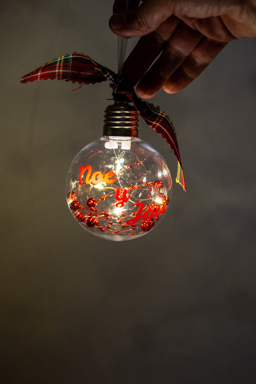 Lit LED ornament with the red names Noe and Javi and red beads.