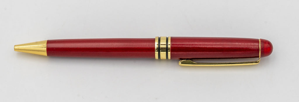 Reddish wooden pen without a cap, with a gold-coloured clip and tip.
