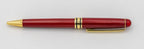 Reddish wooden pen without a cap, with a gold-coloured clip and tip.