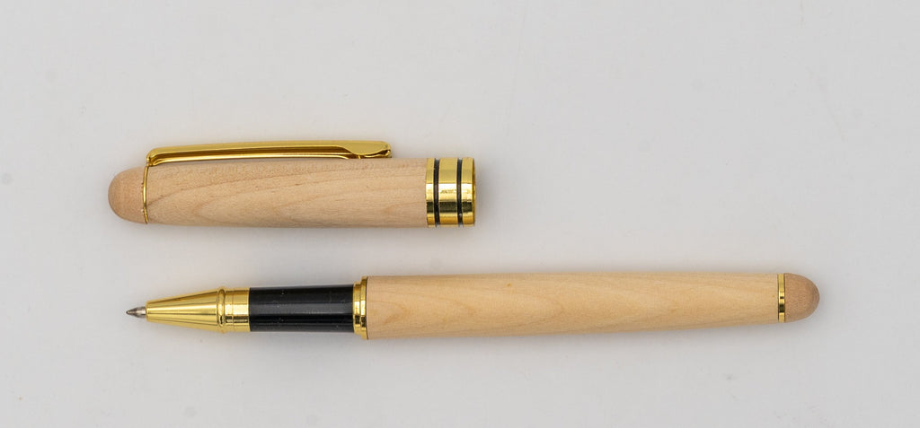 Pale wooden pen with its cap removed, a gold-coloured clip and a black grip.