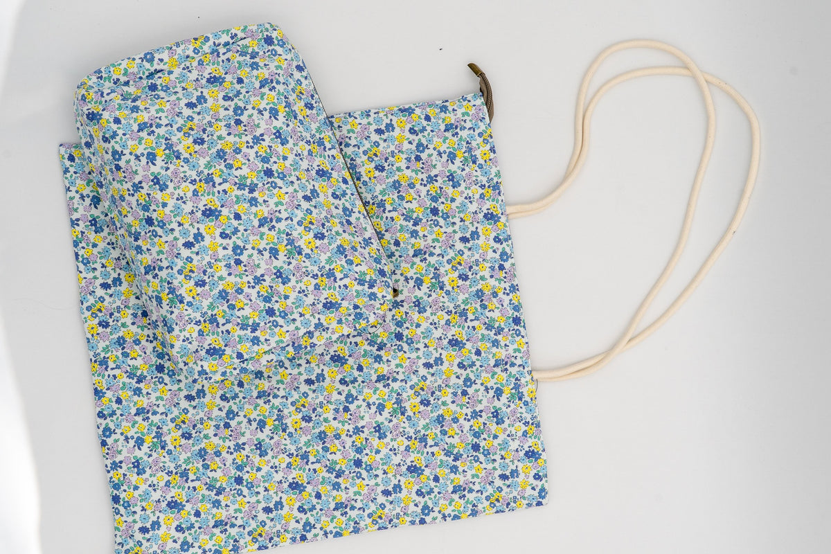 Wash bag and bag set with a small blue and yellow flower design.