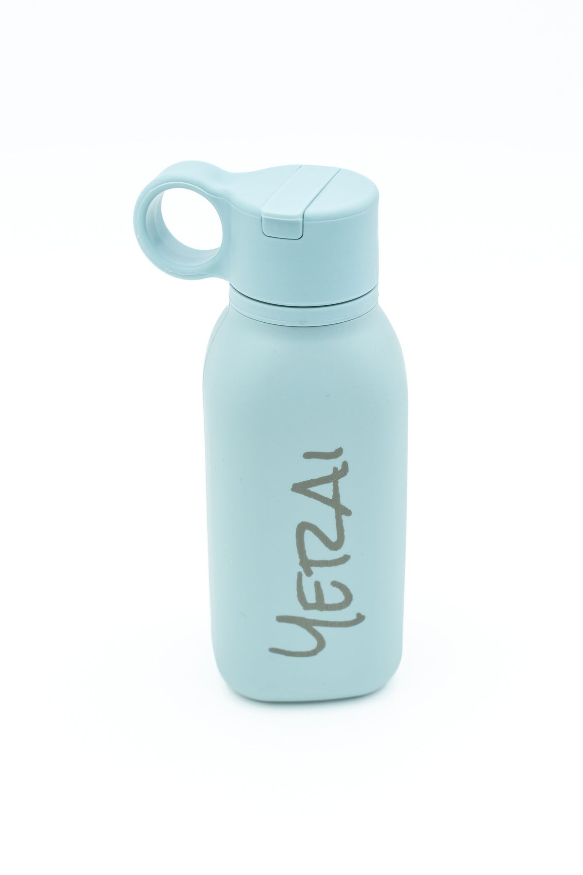 Light blue bottle with a vertically engraved name