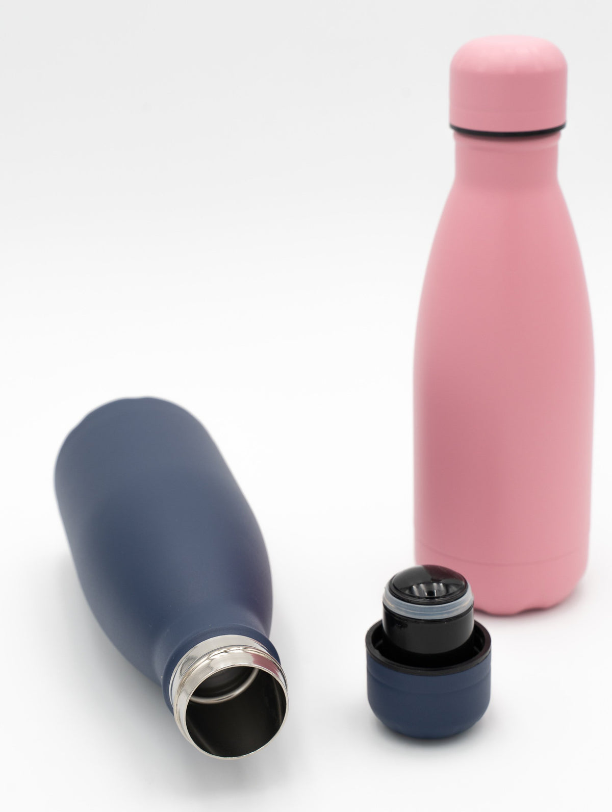 Navy blue and pink insulated bottles, one open next to its screw cap