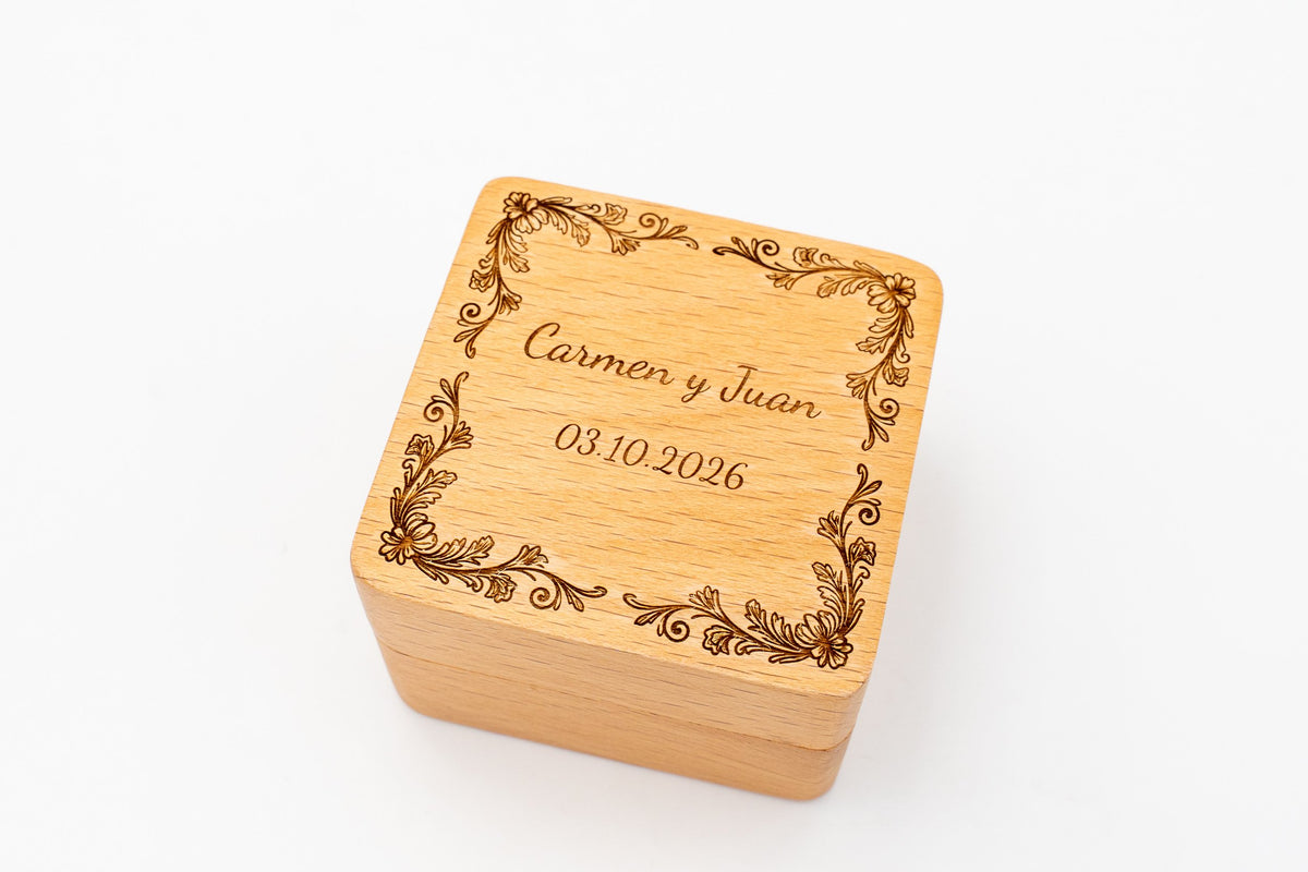 Square beech ring box, laser-engraved, with a floral border, the names Carmen and Juan and the date