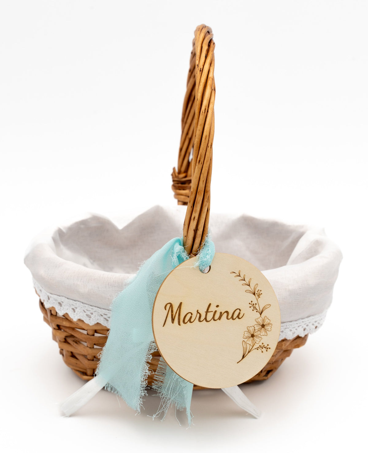 Wicker basket with white fabric lining, lace and a light blue bow