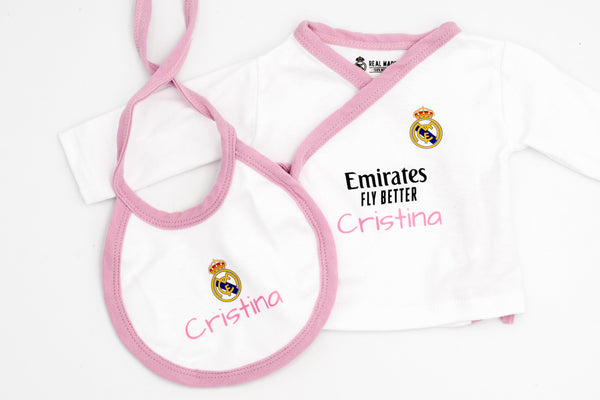 White Real Madrid vest with pink trim and the name Cristina in pink, next to the bib