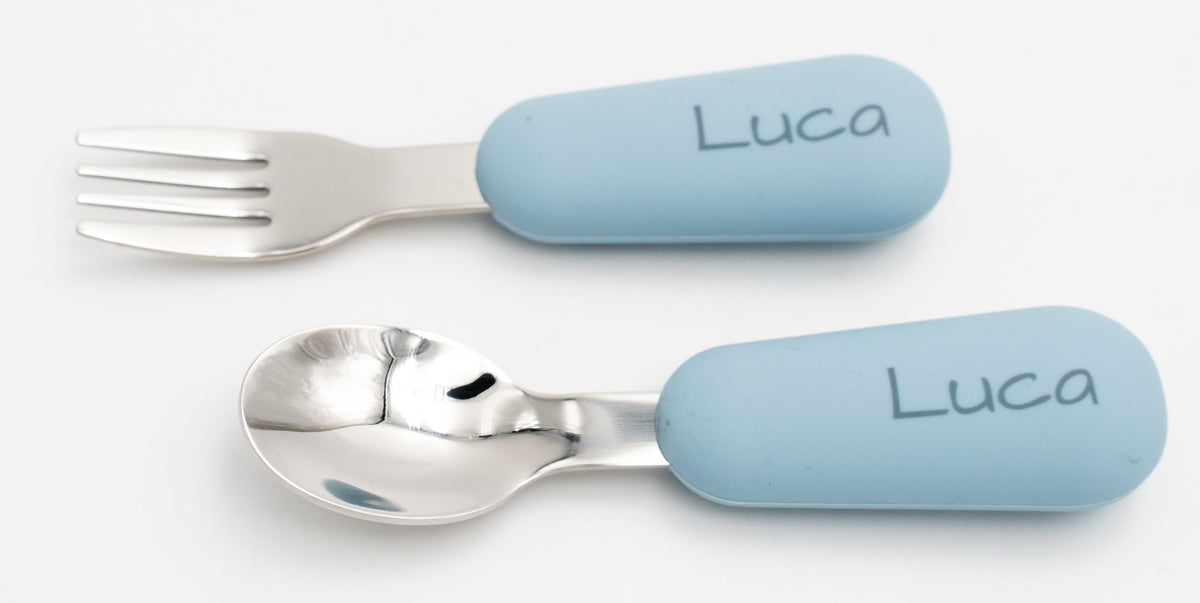 Blue baby spoon and fork with the name Luca engraved on the handles