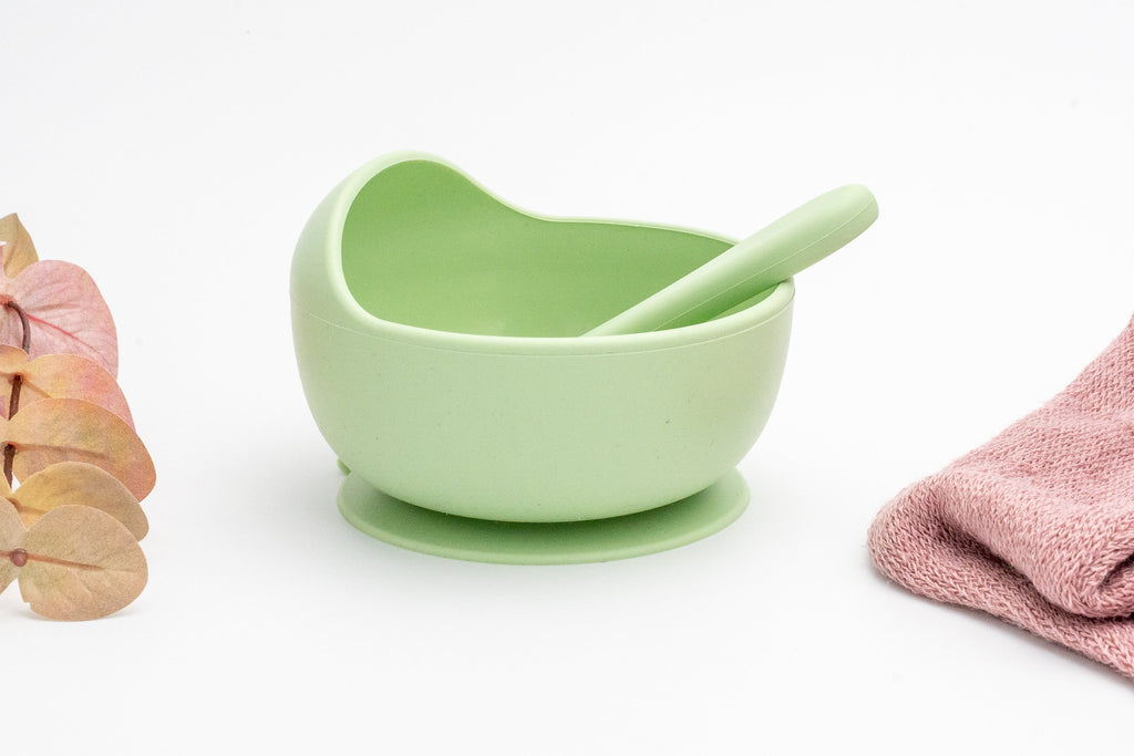 Light green silicone bowl with suction base and matching spoon