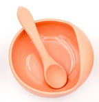 Top view of the clay-coloured bowl with a silicone spoon