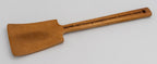 Espátula de madera de acacia con forma rectangular y mango largo con grabado lateral.