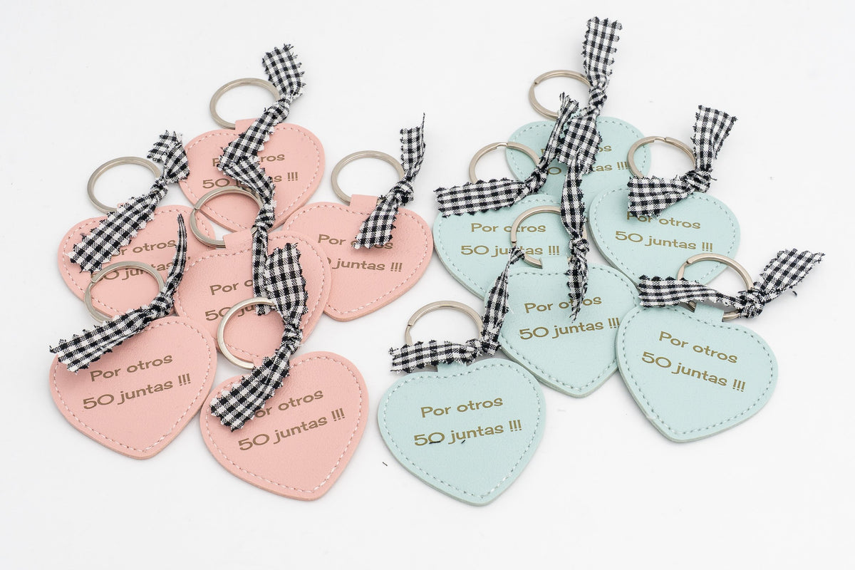 Group of pink and turquoise heart keyrings with wording and black gingham bows.