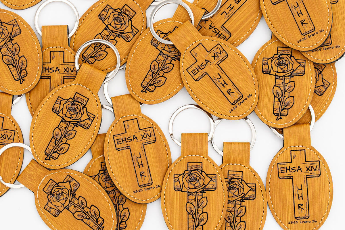 Group of wood-effect oval keyrings with crosses and dark religious motifs.