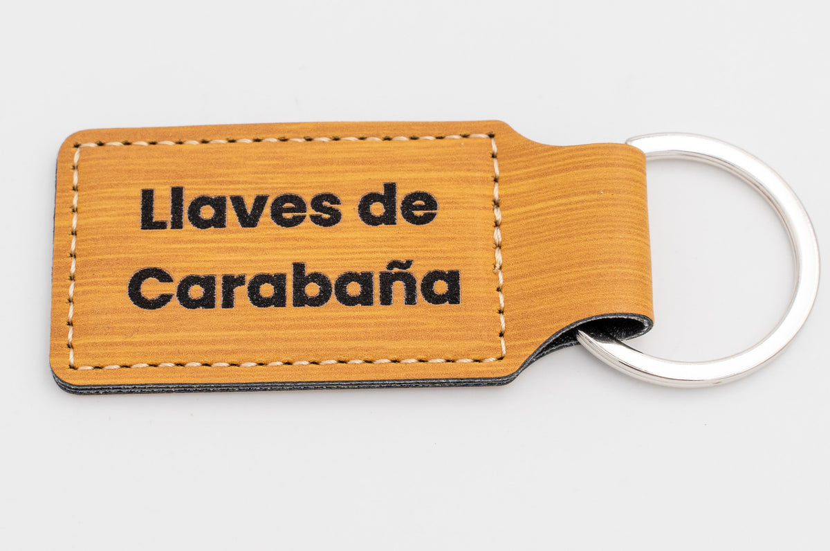 Wood-effect rectangular keyring with dark text on two lines.
