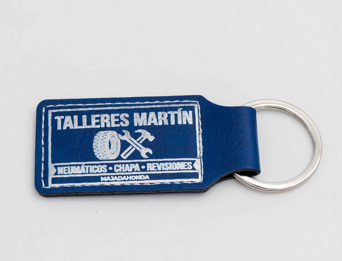 Blue rectangular keyring with a light car workshop design.