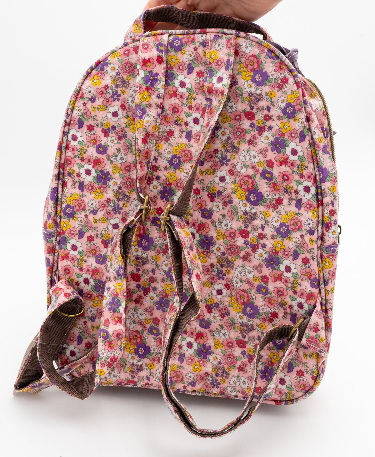 Back of the floral backpack with two adjustable straps and top handle