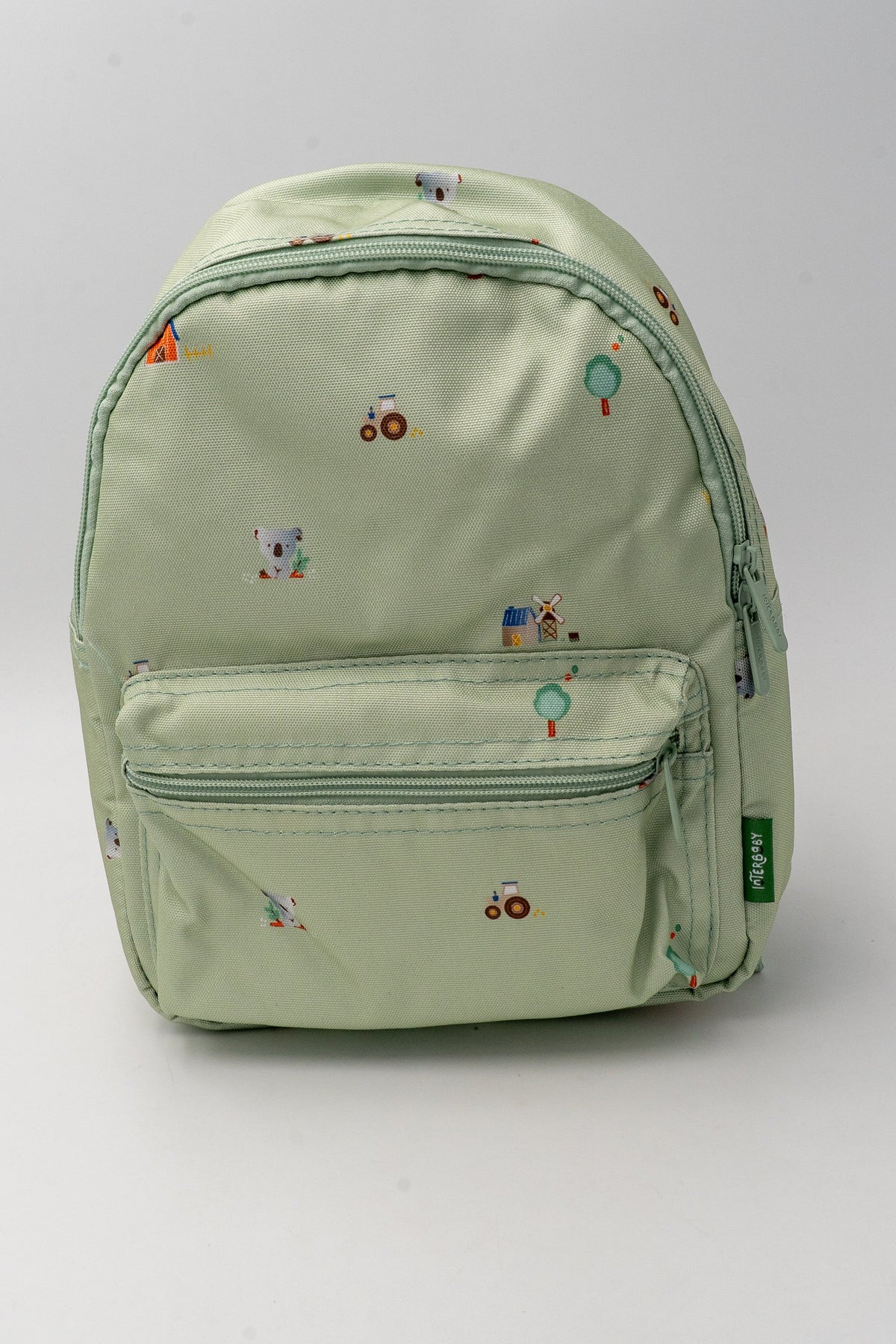 Green nylon children's backpack viewed from the front with a small motif print and zipped pocket