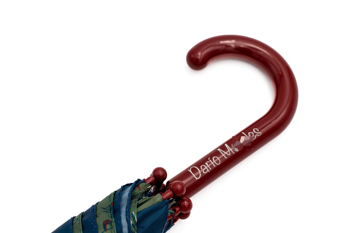 Burgundy children's umbrella handle with a boy's name printed on it